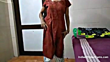 A Indian housewife masturbates in a hotel room wearing brown salwar kameez