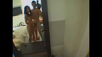 Older woman and younger man engage in explicit sexual activity at a hotel