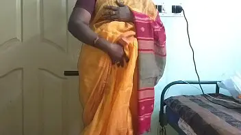 A horny Indian wife wears orange saree exposes big boobs and shaved pubes