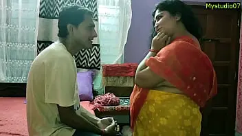 A mature Indian woman engages in explicit adult content with a young boy